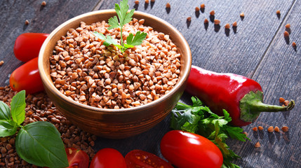 Bowl of buckwheat kasha on wooden table