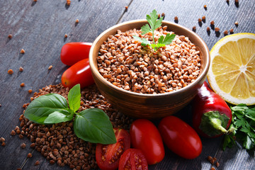 Bowl of buckwheat kasha on wooden table