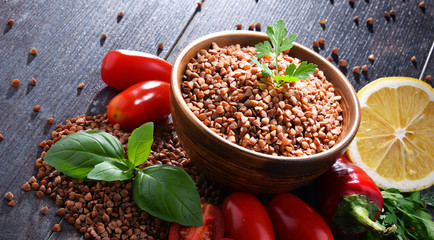 Bowl of buckwheat kasha on wooden table