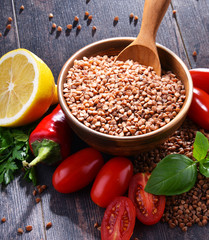 Bowl of buckwheat kasha on wooden table