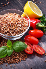 Bowl of buckwheat kasha on wooden table