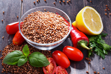 Bowl of buckwheat kasha on wooden table