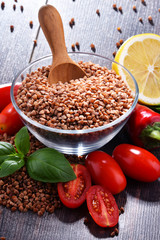 Bowl of buckwheat kasha on wooden table