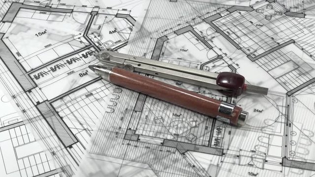 Workplace Architect: professinoalny tools - pencil and compasses smoothly rotate on the surface of the architectural plan of a modern house / seamless looping