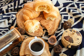 Warm flat lay composition with cup of coffee and croissants.