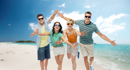 travel, summer holidays and tourism concept - group of happy smiling friends in sunglasses having...