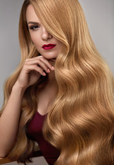 Hair Style. Beautiful Woman With Healthy Wavy Long Blonde Hair