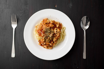 Spaghetti on black wooden background