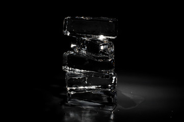 Four ice blocks isolated on the black background