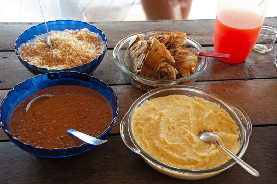 Indigenous food over a wooden table in a village in the Brazilian Amazon