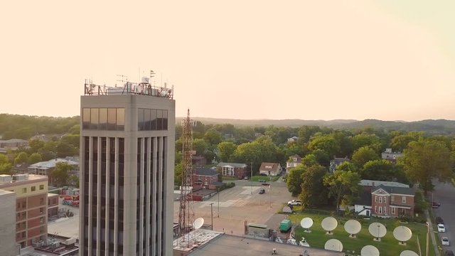 Aerial footage circling around a building in the city on a golden afternoon.