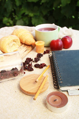 Morning flat lay with croissants,tea,fruits and notebook.