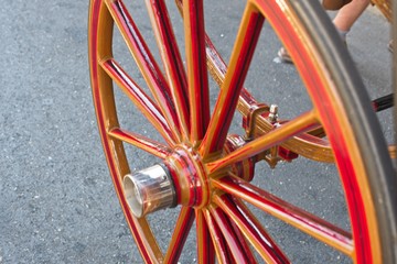 Red Wooden Spoke Wheel from a Horse-drawn Carriage.Close-up