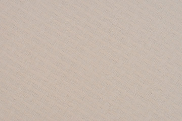 close up of a woolen fabric of beige color. Abstract background, empty template.