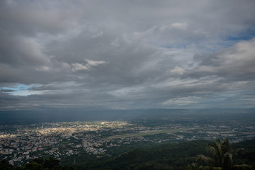 The view from the balcony to see the city and the cloudy sky in the evening and with some part of light in the city. 