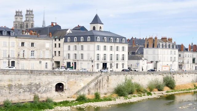 Bank of the loire, in Orléans, city of France, during the summer. We can see the cathedral, and historic buildings. Horizontal panorama.
