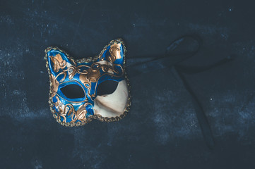 Venetian mask on dark background, top view. Carnival, mystery, masking and halloween concept 