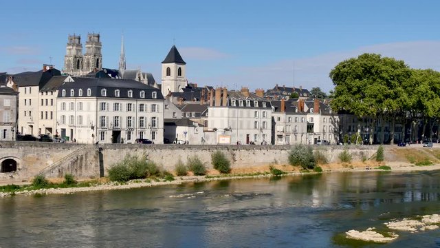 Bank of the loire, in Orléans, city of France, during the summer. We can see the cathedral, and historic buildings.