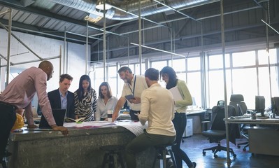 Business people discussing over blueprint in the meeting