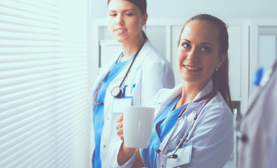 Young team or group of doctors standing in hospital