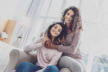 Happy sisters. Pleased girls spending their time with leisure, looking forward