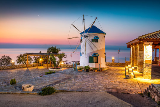 Fabulous morning scene on the Potamitis Windmill. Colorful spring sunrise on the Zakynthos island, Ionian Sea, Greece, Europe. Beauty of countryside concept background.