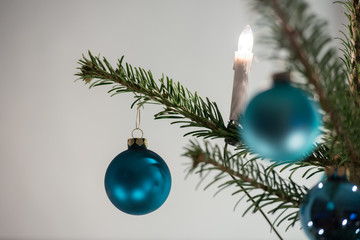 christmas tree balls and a chain of lights on a christmas tree