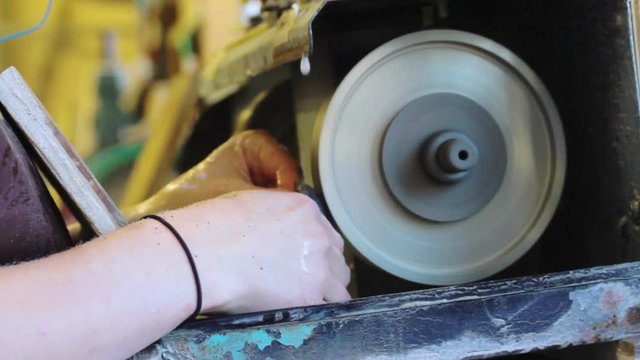 A woman working with a stone grinder.