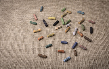 Crayons of various color on a canvas