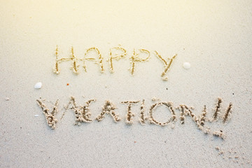 happy vacation written on sands