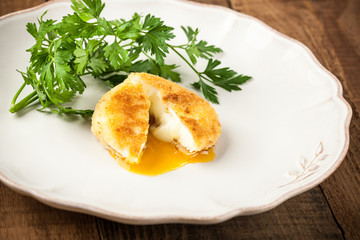 Fried poached egg on a plate
