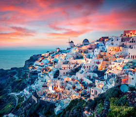 Fototapeta Impressive evening view of Santorini island. Picturesque spring sunset on the famous Greek resort Oia, Greece, Europe. Traveling concept background. Artistic style post processed photo. obraz