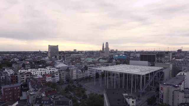 AERIAL: rising above concert hall in antwerp belgium with notre dame cathedral in the background