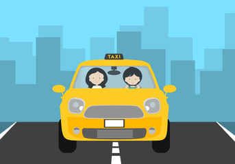A young driver man driving a yellow car with a passenger and a TAXI sign. Gray asphalt road with white stripes and green lawn, with city buildings in the background under blue sky and space for text.