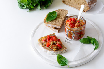 Rye bread toasts and glass jar with eggplant caviar. Vegetable appetizer or antipasti. Healthy food concept