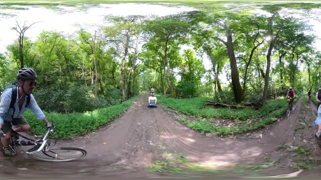 4K 360 vr of elderly man pulling a trailer with a dog and a family biking on a dirt trail at C&O Canal National Park.