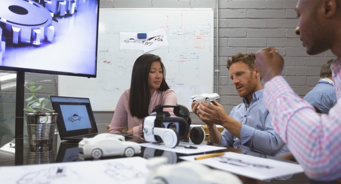 Business colleagues discussing over car model