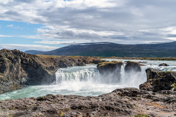 Godafoss waterfall, or waterfall of the gods - Northern Iceland. The water of the river Skjalfandafljot falls from a height of 12 meters over a width of 30 meters.