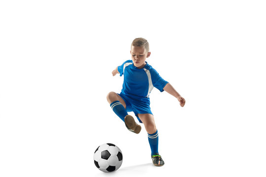 Young boy with soccer ball doing flying kick, isolated on white. football soccer players in motion on studio background. Fit jumping boy in action, jump, movement at game.