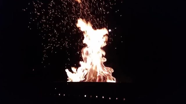 Slowmotion video of fire burning in the night