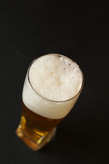 Light beer in a glass bowl on a black background. Beer in the bar