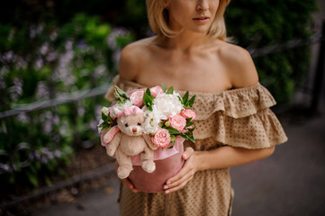 Blonde woman holding a box filled with flowers