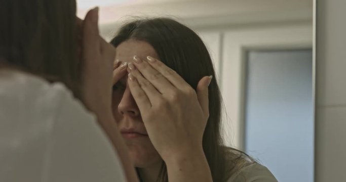 Woman is looking for wrinkles