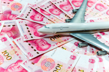 Fototapeta na wymiar Yuan or RMB, Chinese Currency and airplane