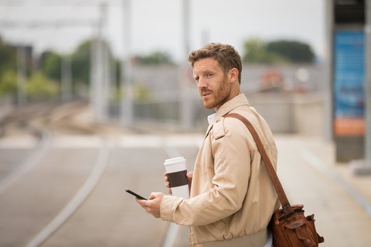 Man using mobile phone in platform