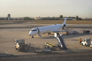 Airplane at the airport at sunset