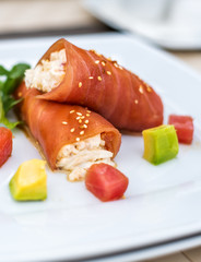 rolls of tuna with crab meat on the plate
