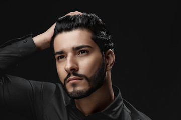 Men Hair Care. Man With Beard, Beauty Face Touching Black Hair