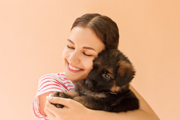 Obraz premium Beautiful girl hugging tight her cute small puppy