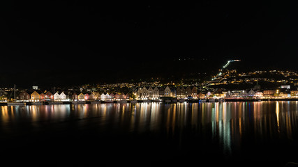 Fototapeta na wymiar Bergen norway brygge by night with reflection in the water, norway, europe